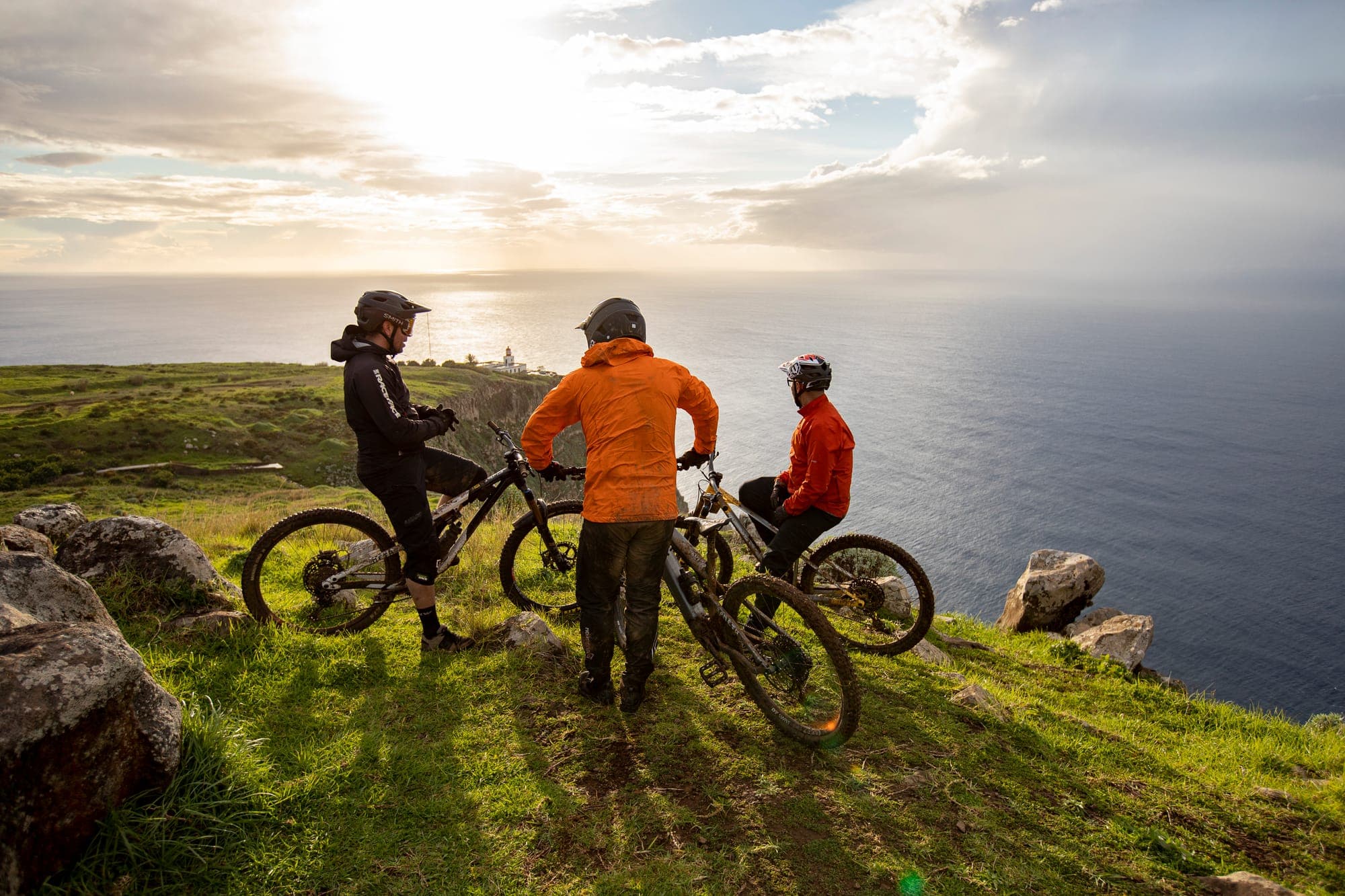 Riders stopped on a clifftop above the sea